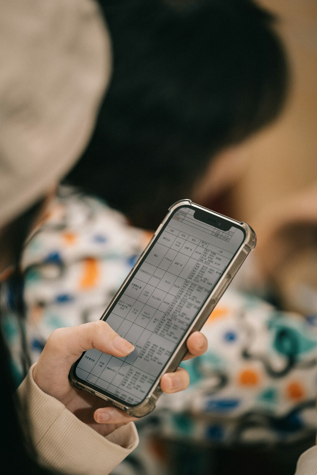 person using smartphone for voting